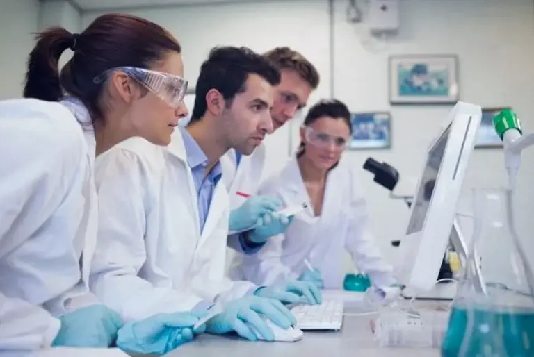 Lab technicians at a computer