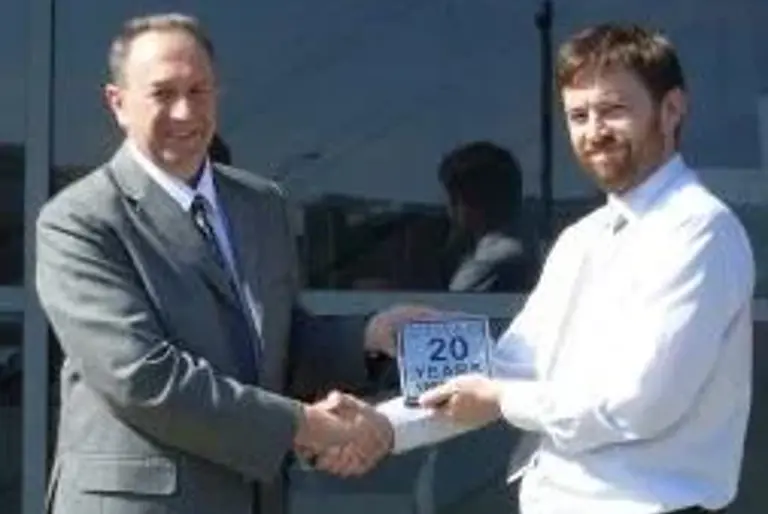 Joe Noble presenting Robert Franks with plaque